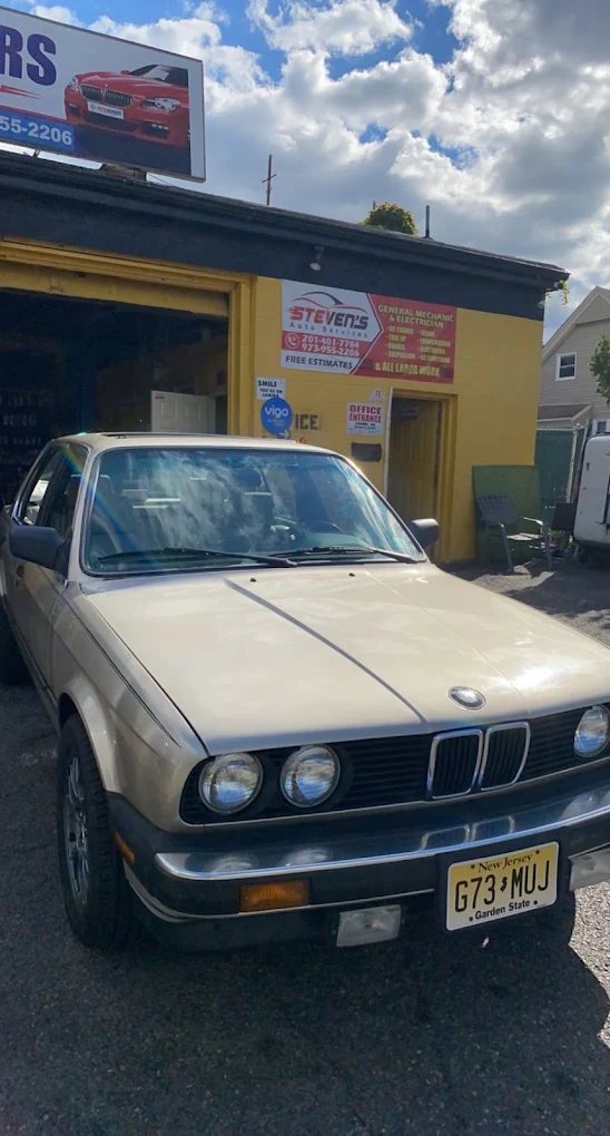 Classic BMW E30 outside the shop