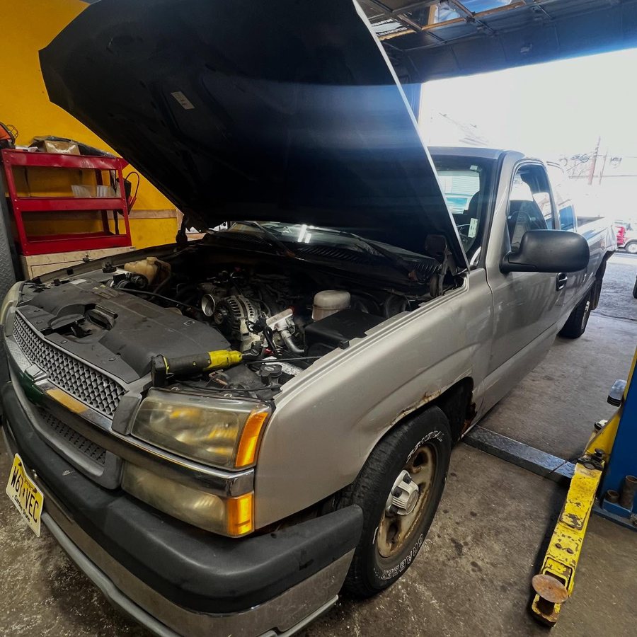 Pickup truck with the hood open in the bay